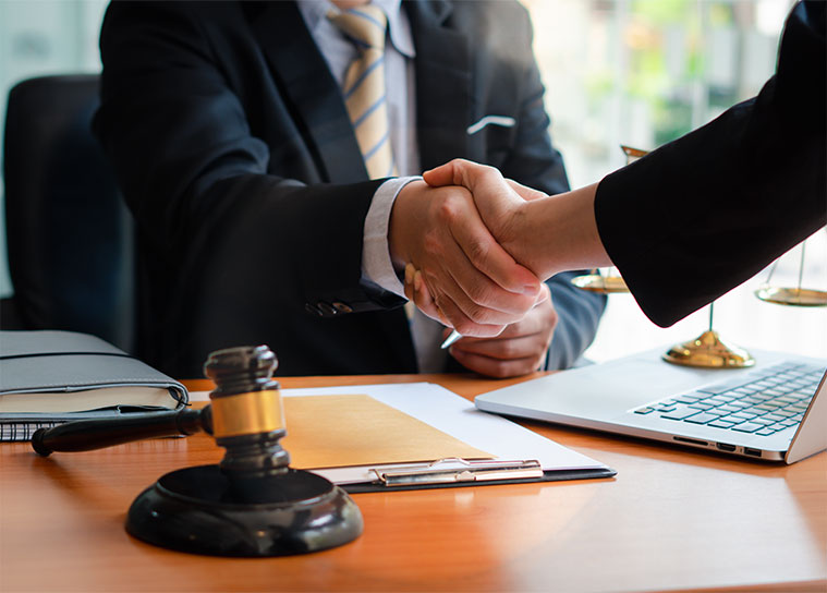 Image of a client and lawyer with legal documents and a gavel, symbolizing wealth preservation and legacy planning